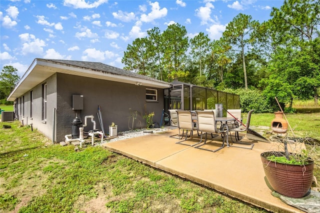 2685 W Apricot Dr, Beverly Hills, FL 34465 - rear view of house featuring stucco siding, a patio, outdoor dining area, and a lawn