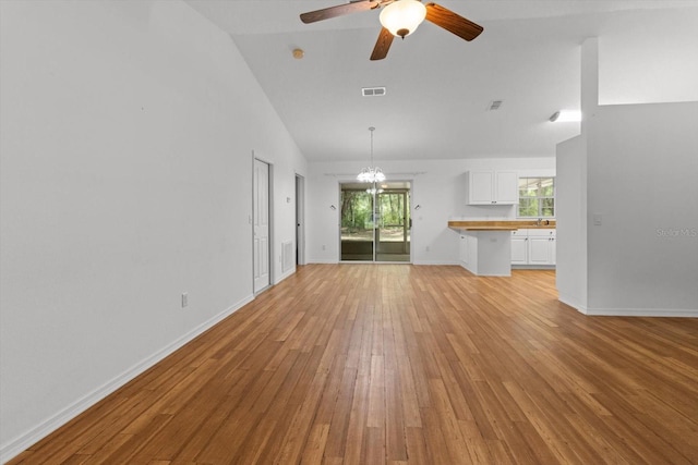 2105 E Dearborn Dr, Hernando, FL 34442 - unfurnished living room with light wood-style floors, a chandelier, a ceiling fan, and high vaulted ceiling