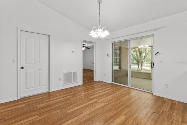 2105 E Dearborn Dr, Hernando, FL 34442 - unfurnished dining area with a chandelier, light wood finished floors, vaulted ceiling, and a ceiling fan