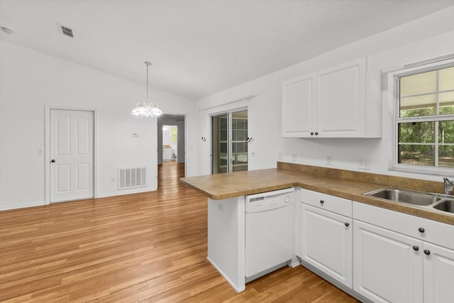 2105 E Dearborn Dr, Hernando, FL 34442 - kitchen featuring white dishwasher, vaulted ceiling, a peninsula, light wood-type flooring, and white cabinets