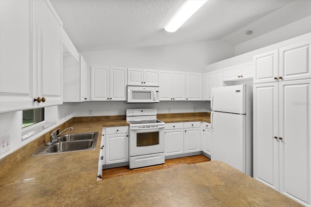 2105 E Dearborn Dr, Hernando, FL 34442 - kitchen featuring white appliances, lofted ceiling, white cabinets, a textured ceiling, and dark countertops