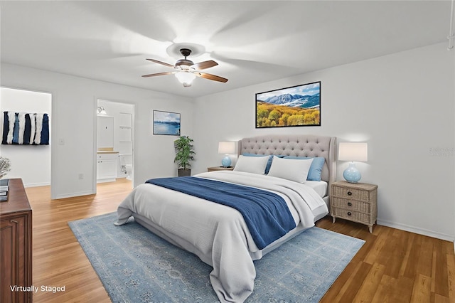 2105 E Dearborn Dr, Hernando, FL 34442 - bedroom with light wood-type flooring, a ceiling fan, and connected bathroom