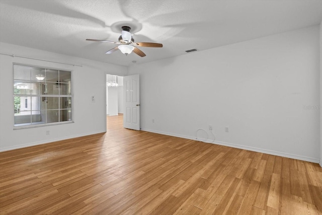 2105 E Dearborn Dr, Hernando, FL 34442 - unfurnished room with a ceiling fan, light wood finished floors, and a chandelier