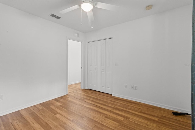 2105 E Dearborn Dr, Hernando, FL 34442 - unfurnished bedroom with light wood-type flooring, a closet, and a ceiling fan