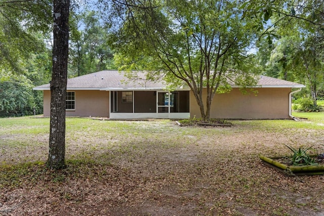 2105 E Dearborn Dr, Hernando, FL 34442 - back of house with a sunroom, a yard, and stucco siding