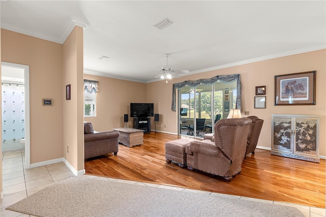 5543 NW 25th Loop, Ocala, FL 34482 - living room with ornamental molding, plenty of natural light, a ceiling fan, and wood finished floors