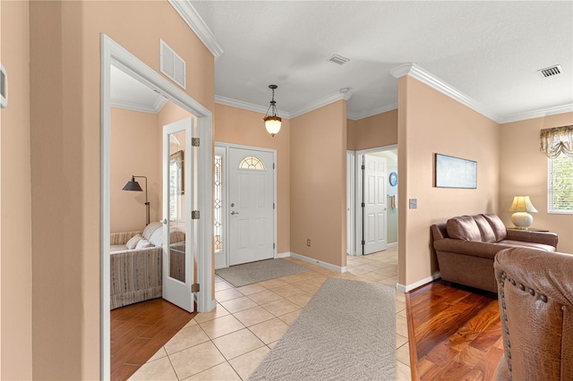 5543 NW 25th Loop, Ocala, FL 34482 - foyer entrance featuring ornamental molding, light wood-type flooring, and a chandelier