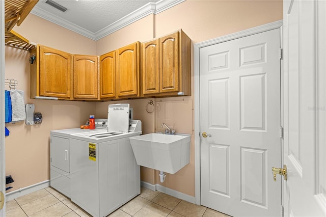 5543 NW 25th Loop, Ocala, FL 34482 - laundry room featuring washing machine and dryer, cabinet space, crown molding, light tile patterned floors, and a textured ceiling