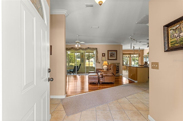 5543 NW 25th Loop, Ocala, FL 34482 - entrance foyer featuring ceiling fan, light tile patterned floors, crown molding, and track lighting