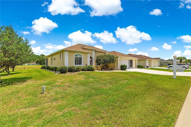 5543 NW 25th Loop, Ocala, FL 34482 - mediterranean / spanish house featuring a garage, concrete driveway, a front lawn, and stucco siding