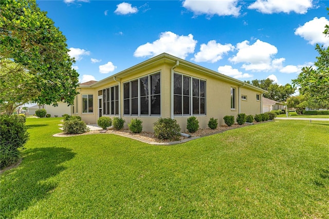 5543 NW 25th Loop, Ocala, FL 34482 - back of property featuring a yard and stucco siding