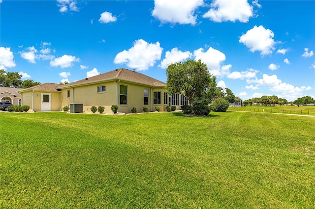 5543 NW 25th Loop, Ocala, FL 34482 - rear view of house with stucco siding and a yard