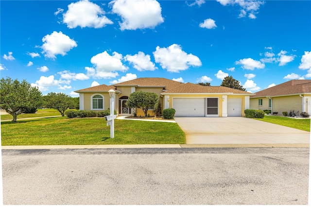 5543 NW 25th Loop, Ocala, FL 34482 - view of front of home featuring a garage, concrete driveway, a front yard, and stucco siding