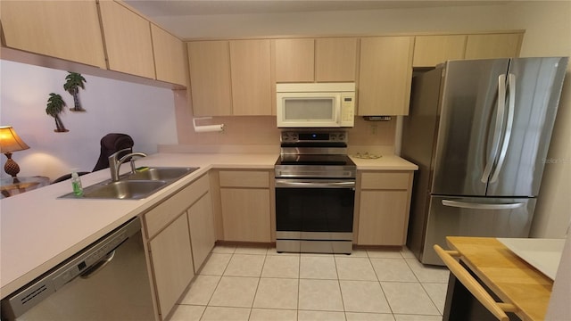 6421 Remus Dr, New Port Richey, FL 34653 - kitchen featuring appliances with stainless steel finishes, light brown cabinets, light countertops, and light tile patterned floors