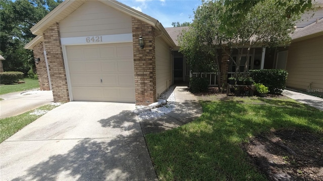 6421 Remus Dr, New Port Richey, FL 34653 - view of front of house with brick siding, an attached garage, concrete driveway, a front yard, and a shingled roof