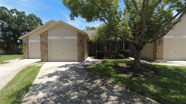 6421 Remus Dr, New Port Richey, FL 34653 - view of front of property with brick siding, a garage, driveway, and a front lawn