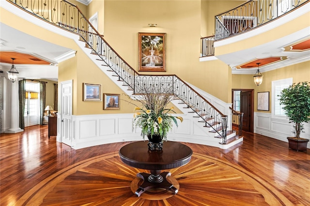 17800 SE 237th Ct, Umatilla, FL 32784 - entryway featuring healthy amount of natural light, a high ceiling, stairs, wood finished floors, and ornamental molding
