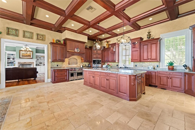 17800 SE 237th Ct, Umatilla, FL 32784 - kitchen with double oven range, a chandelier, tasteful backsplash, coffered ceiling, and stone tile floors