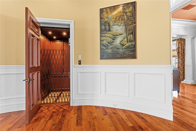 17800 SE 237th Ct, Umatilla, FL 32784 - hallway featuring wood finished floors, a wainscoted wall, and a decorative wall