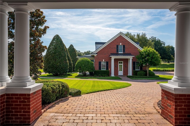17800 SE 237th Ct, Umatilla, FL 32784 - view of front facade with curved driveway, brick siding, and a front lawn