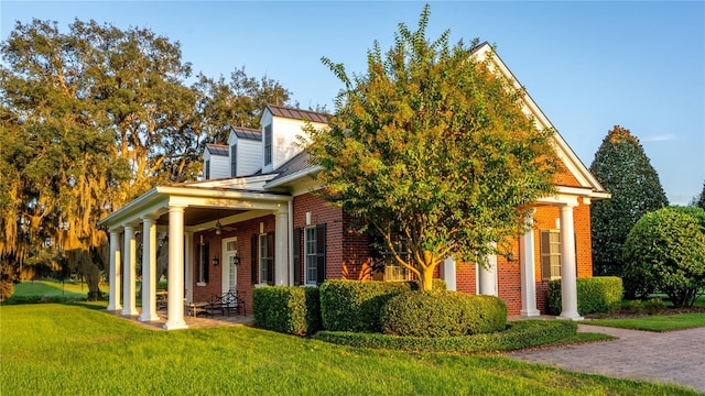 17800 SE 237th Ct, Umatilla, FL 32784 - view of front facade with a ceiling fan, a front lawn, brick siding, a standing seam roof, and a metal roof