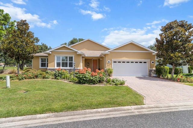 9251 SW 94th Loop, Ocala, FL 34481 - single story home with stone siding, a garage, decorative driveway, and stucco siding