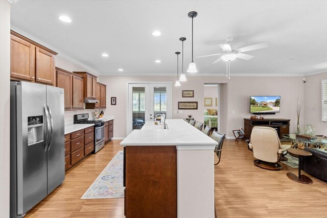 9251 SW 94th Loop, Ocala, FL 34481 - kitchen featuring appliances with stainless steel finishes, light countertops, light wood-type flooring, ceiling fan, and ornamental molding