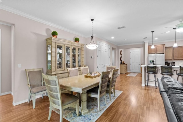 9251 SW 94th Loop, Ocala, FL 34481 - dining space with light wood-style flooring, ceiling fan, ornamental molding, and recessed lighting