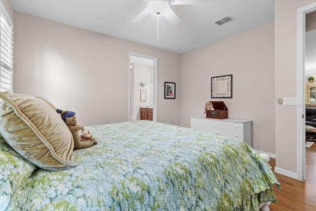 9251 SW 94th Loop, Ocala, FL 34481 - bedroom with wood finished floors, ensuite bathroom, and a ceiling fan