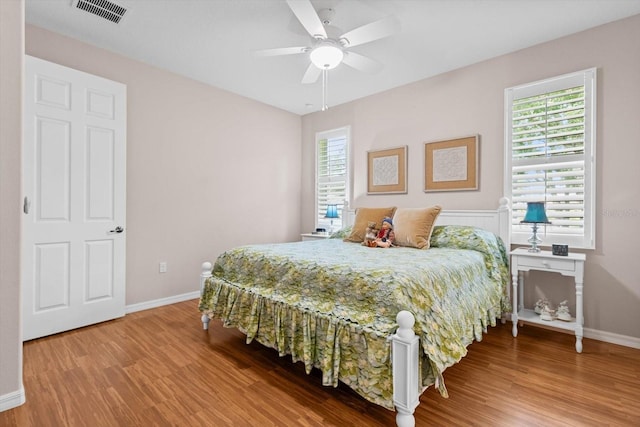9251 SW 94th Loop, Ocala, FL 34481 - bedroom with wood finished floors and a ceiling fan
