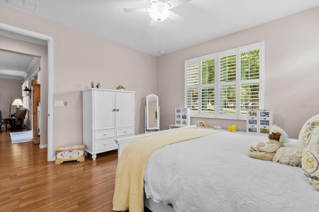 9251 SW 94th Loop, Ocala, FL 34481 - bedroom with wood finished floors and a ceiling fan