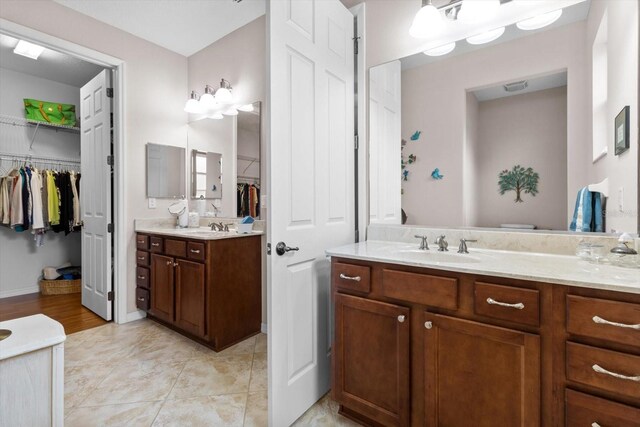 9251 SW 94th Loop, Ocala, FL 34481 - full bathroom with vanity, a walk in closet, and tile patterned floors