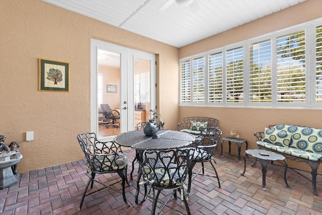 9251 SW 94th Loop, Ocala, FL 34481 - dining room featuring a textured wall, brick flooring, french doors, and a ceiling fan