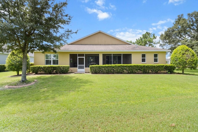 9251 SW 94th Loop, Ocala, FL 34481 - view of front of house featuring a front lawn, stucco siding, and a sunroom