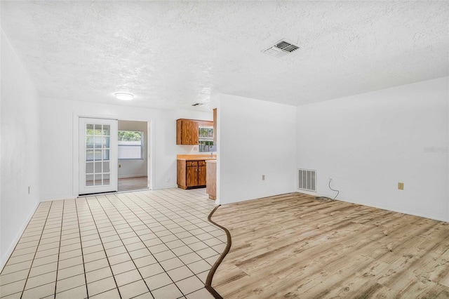 231 S Barbour St, Beverly Hills, FL 34465 - unfurnished living room with light wood-type flooring and a textured ceiling