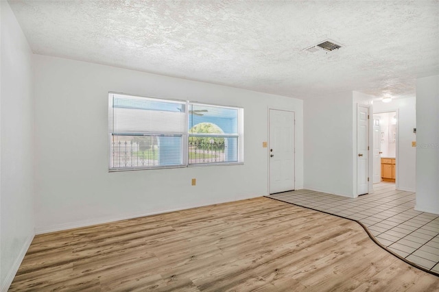 231 S Barbour St, Beverly Hills, FL 34465 - unfurnished room with light wood-type flooring and a textured ceiling