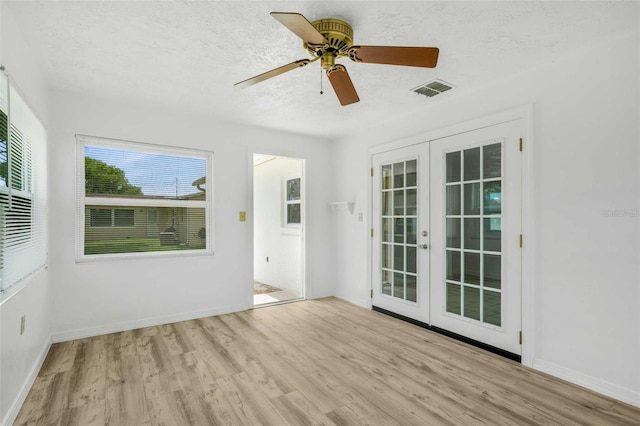 231 S Barbour St, Beverly Hills, FL 34465 - spare room featuring french doors, wood finished floors, a textured ceiling, and a ceiling fan