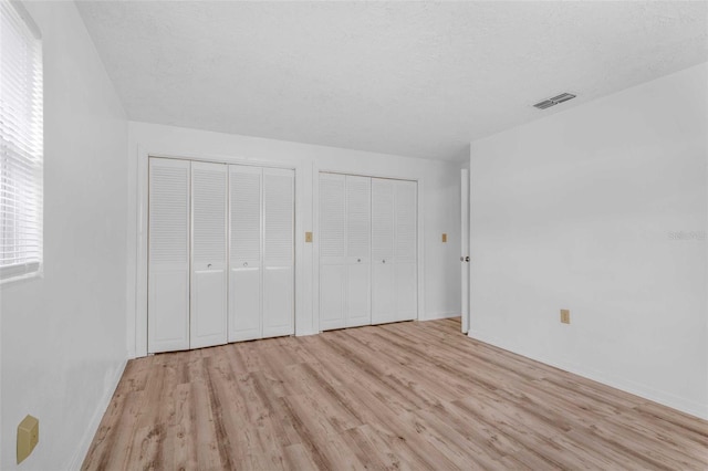 231 S Barbour St, Beverly Hills, FL 34465 - unfurnished bedroom featuring light wood finished floors and two closets