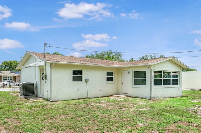 231 S Barbour St, Beverly Hills, FL 34465 - rear view of property with stucco siding and a lawn