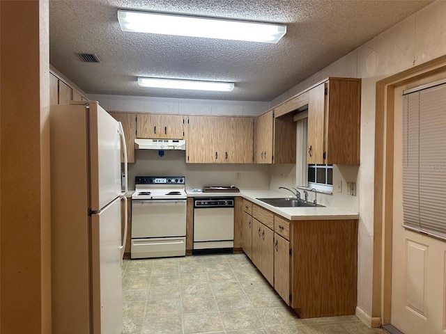 8470 SW 92nd Ln Unit F, Ocala, FL 34481 - kitchen featuring white appliances, under cabinet range hood, a textured ceiling, and light countertops