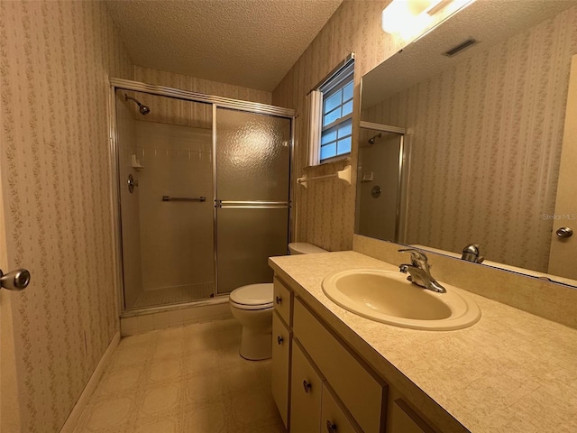 8470 SW 92nd Ln Unit F, Ocala, FL 34481 - bathroom with vanity, a shower stall, a textured ceiling, tile patterned floors, and wallpapered walls