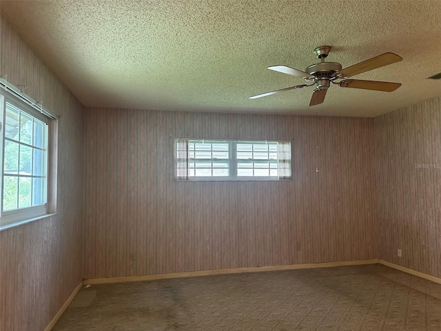 8470 SW 92nd Ln Unit F, Ocala, FL 34481 - unfurnished room featuring plenty of natural light, a textured ceiling, a ceiling fan, and carpet