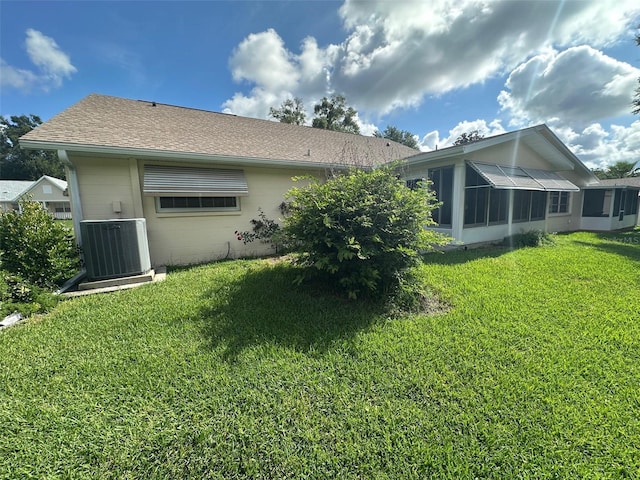 8470 SW 92nd Ln Unit F, Ocala, FL 34481 - back of house with concrete block siding, a yard, a sunroom, and a shingled roof