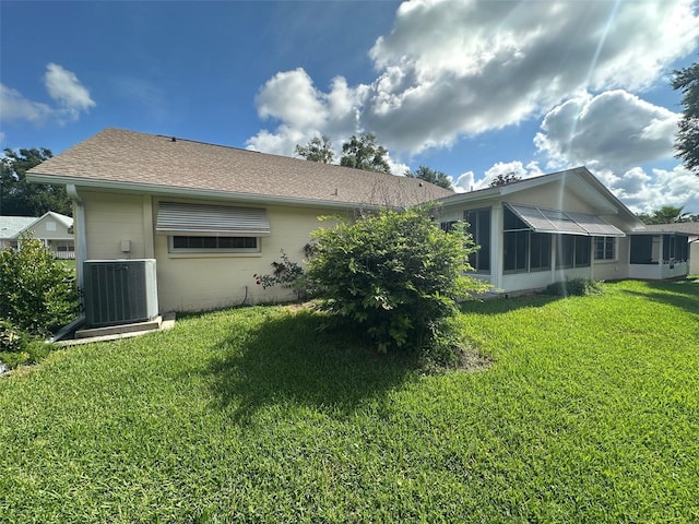 8470 SW 92nd Ln Unit F, Ocala, FL 34481 - back of property featuring a lawn, a sunroom, and concrete block siding