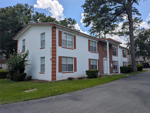 2564 SE 15th Ave Unit G, Ocala, FL 34471 - view of front of home featuring a front lawn