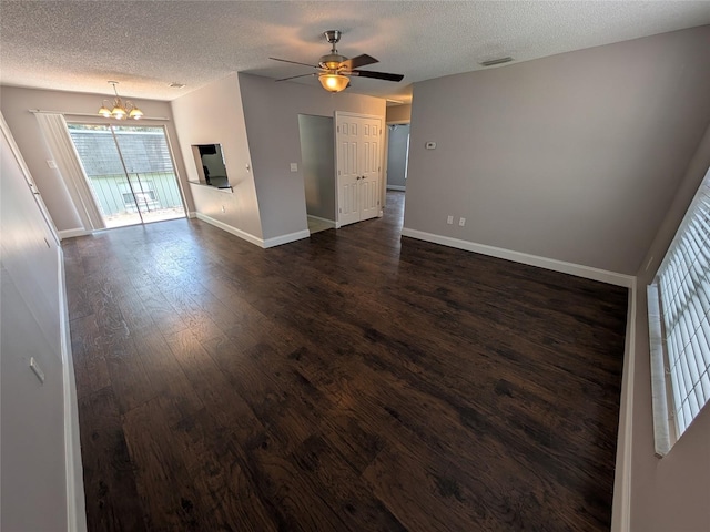 2564 SE 15th Ave Unit G, Ocala, FL 34471 - unfurnished living room with a chandelier, a textured ceiling, dark wood finished floors, and ceiling fan