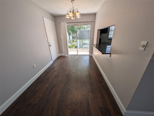 2564 SE 15th Ave Unit G, Ocala, FL 34471 - entryway featuring a chandelier, a textured ceiling, and dark wood finished floors