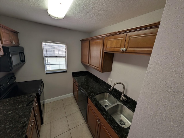 2564 SE 15th Ave Unit G, Ocala, FL 34471 - kitchen featuring black appliances, a textured ceiling, dark stone countertops, light tile patterned floors, and brown cabinets