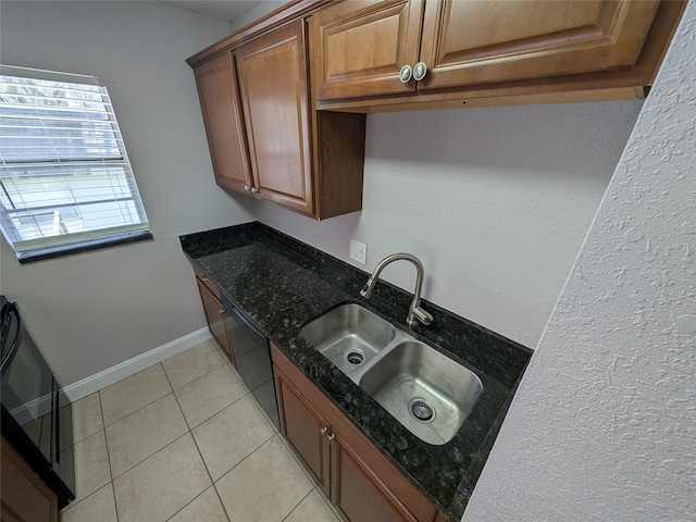 2564 SE 15th Ave Unit G, Ocala, FL 34471 - kitchen featuring light tile patterned floors, brown cabinetry, dark stone counters, and black dishwasher