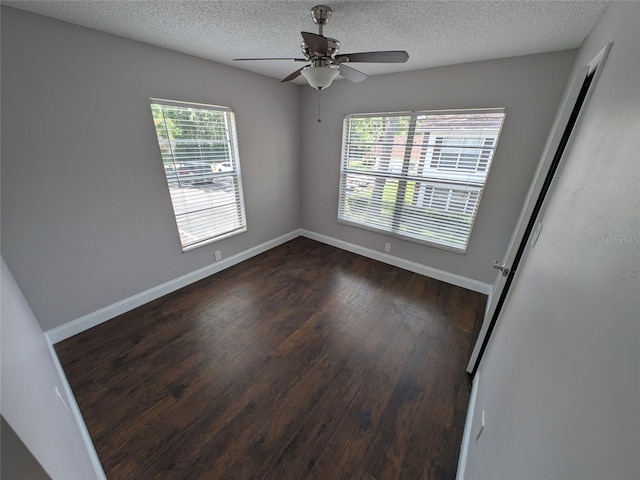 2564 SE 15th Ave Unit G, Ocala, FL 34471 - spare room featuring dark wood-type flooring, a textured ceiling, and ceiling fan